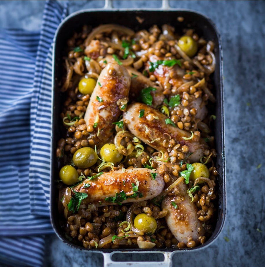 Sausages with braised lentils, lemon and green olives